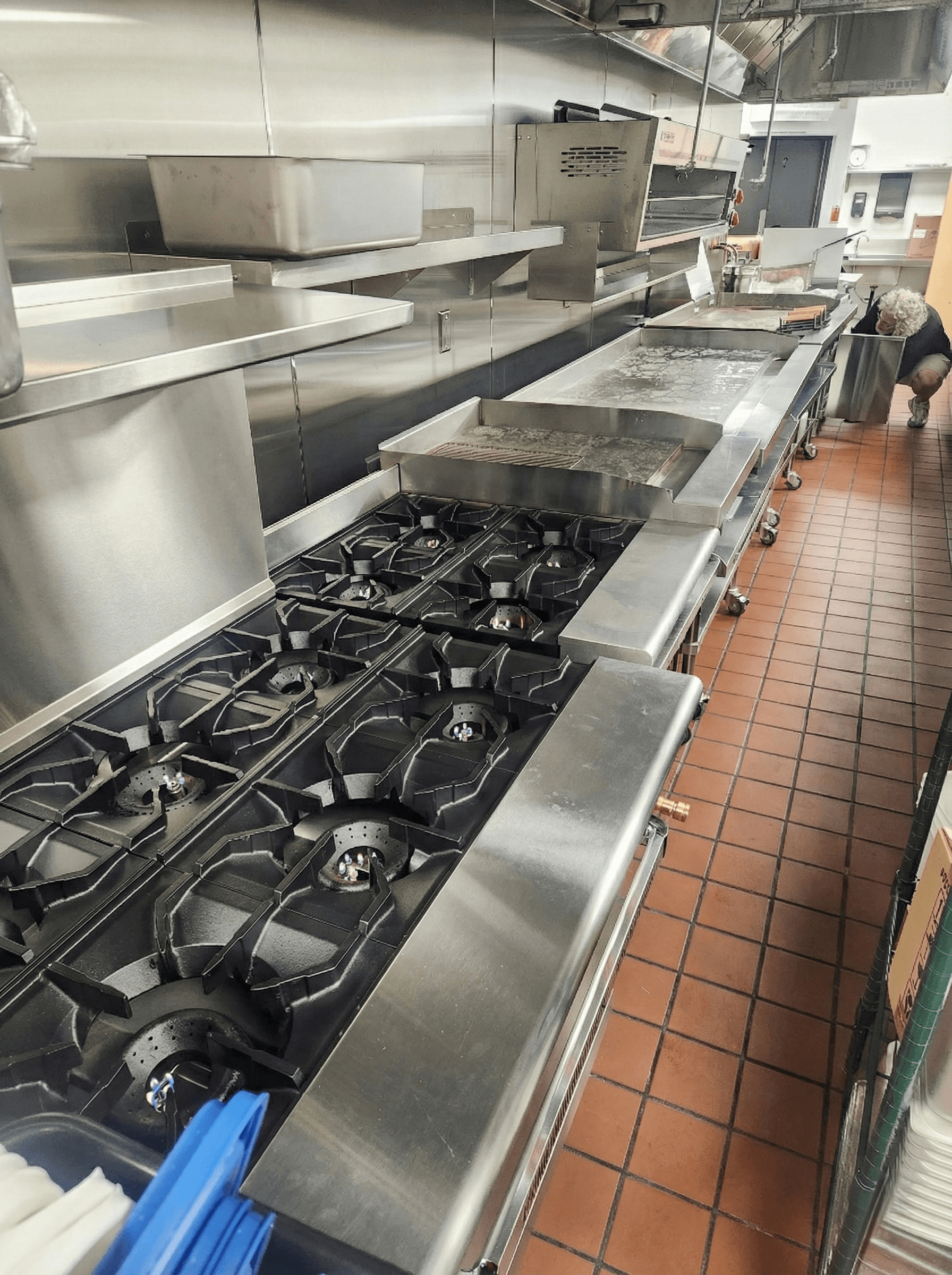 Shiny fryer baskets lowering into fresh oil in the Tempe kitchen