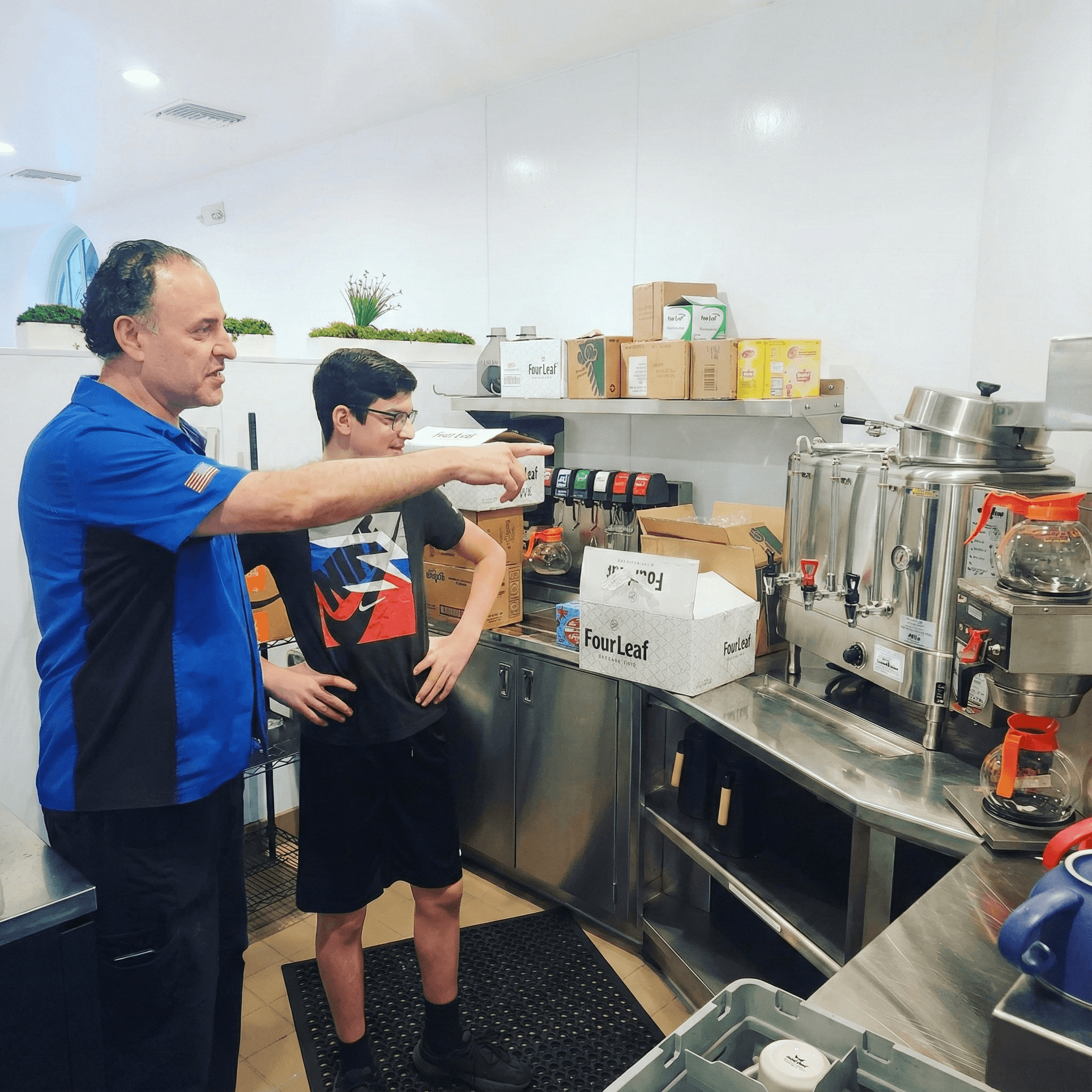 Chef Mario training with his son at the coffee and juice station